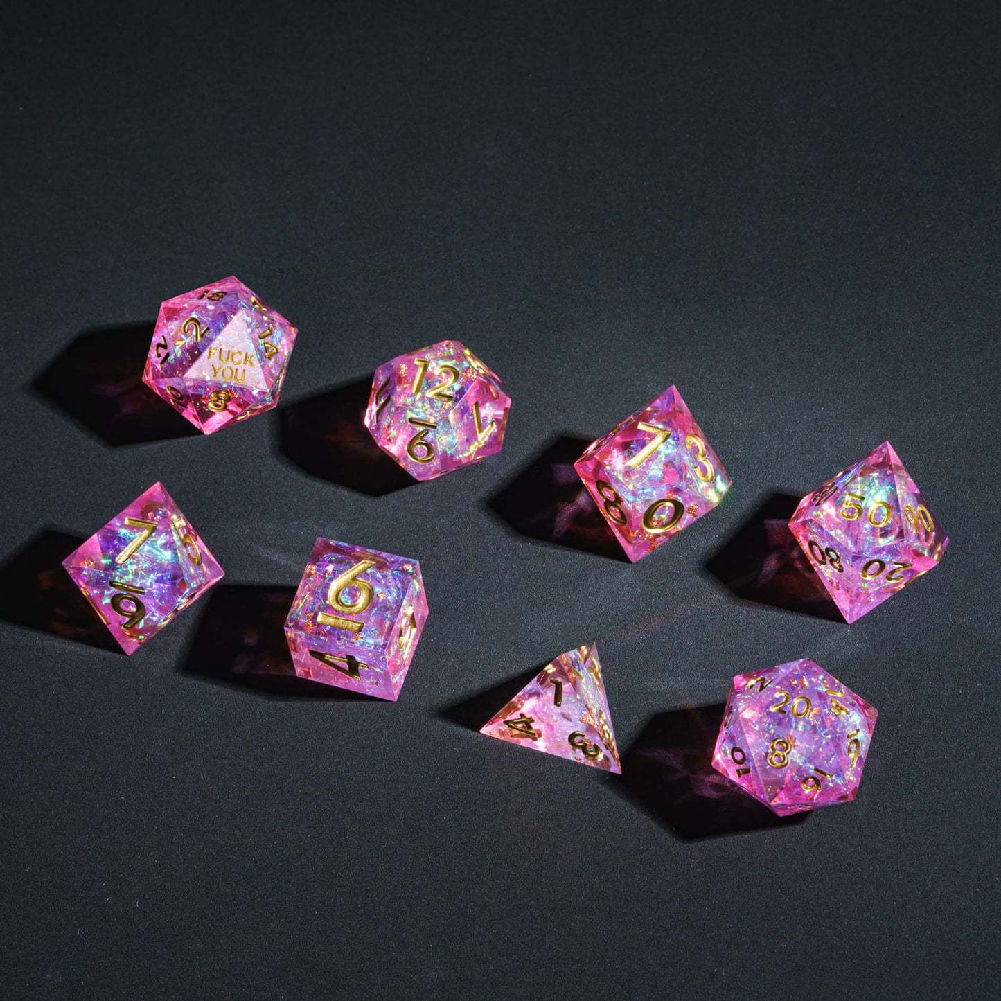 Flat lay of Celestial Heart F*ck Me Sharp Edge Dice Set 7 piece dice collection for DnD & DnD 5e