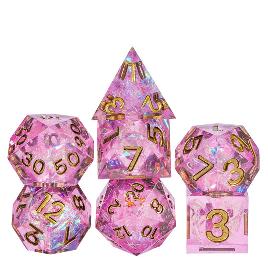 Celestial Heart sharp edge dice set on white background, pink resin DND dice with gold numbering