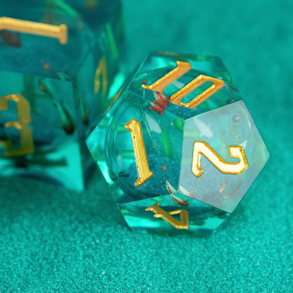 Close up of Celestial Reef D10 with teal resin and gold numbering