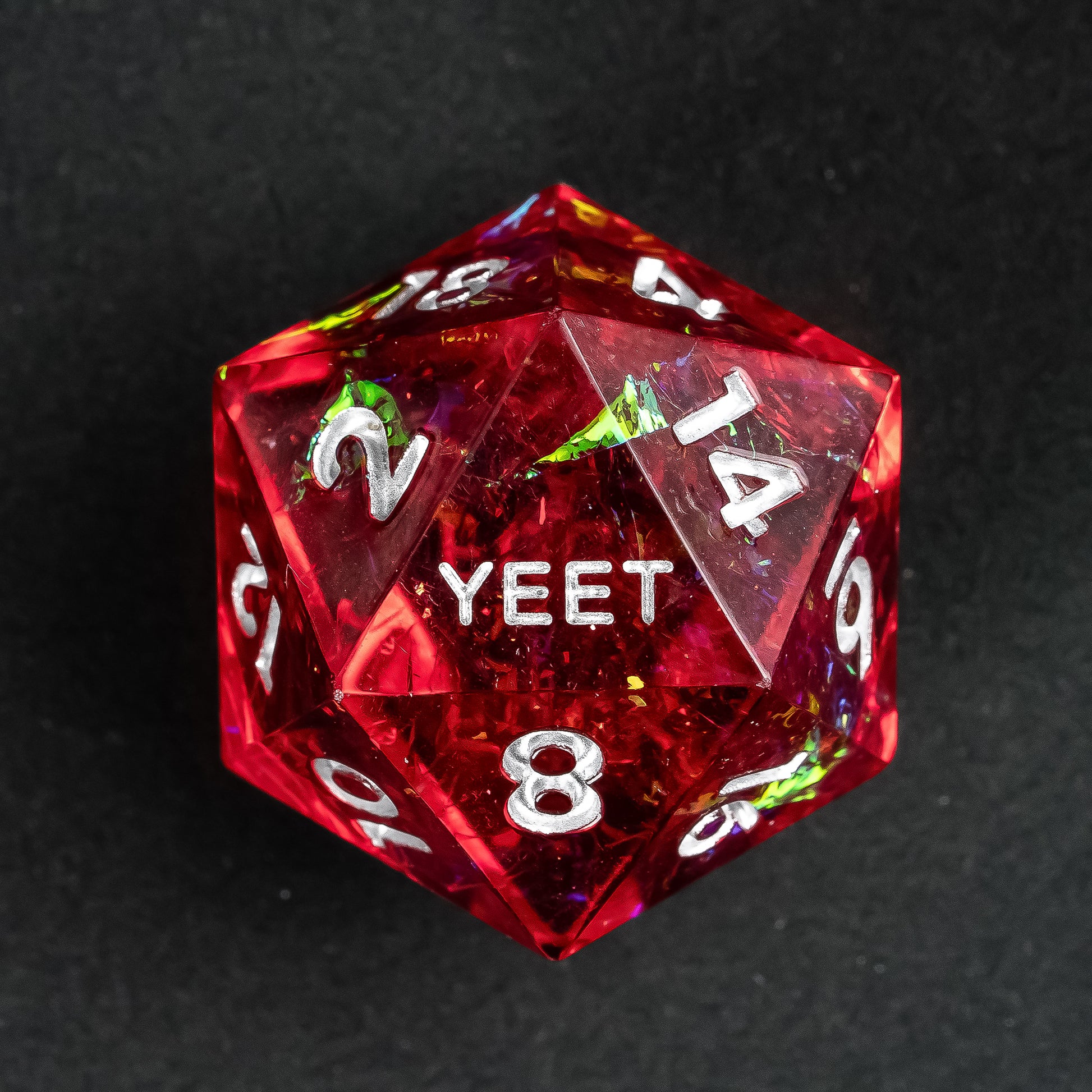 Close-up of Chromatic Blood Yeet Sharp Edge D20 die with sharp edges and bold design for tabletop RPGs