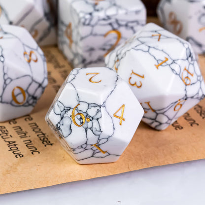 Close-up of Cracked Marble Stone D20 and D6 dice showing gold engraved numbers and marble details