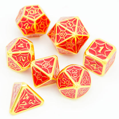 Top view of Crimson Gold Chroma polyhedral metal dice set on white