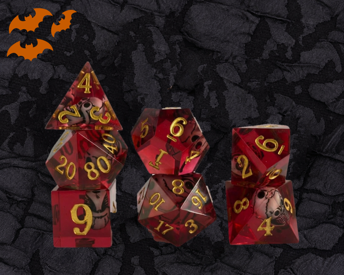 Crimson Skull sharp edge DnD dice set in translucent red resin with a skull inside each die and gold numbers
