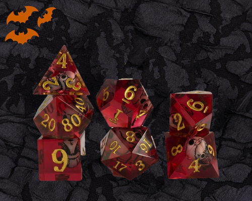 Crimson Skull sharp edge DnD dice set in translucent red resin with a skull inside each die and gold numbers