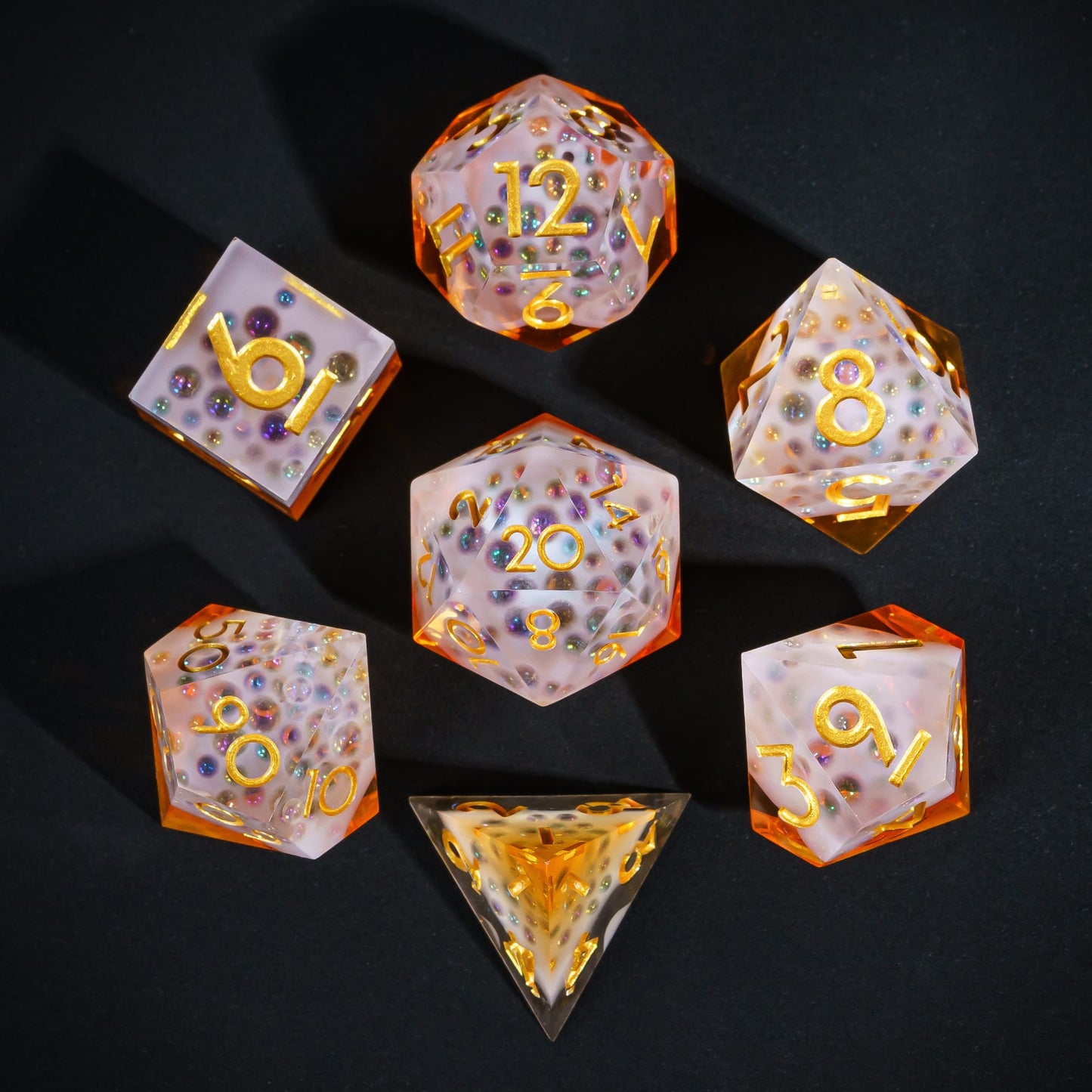 Flat lay of Crisp Brew Sharp Edge Dice Set with amber resin, frosted tops, and gold numbers