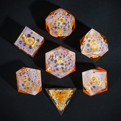 Flat lay of Crisp Brew Sharp Edge Dice Set with amber resin, frosted tops, and gold numbers