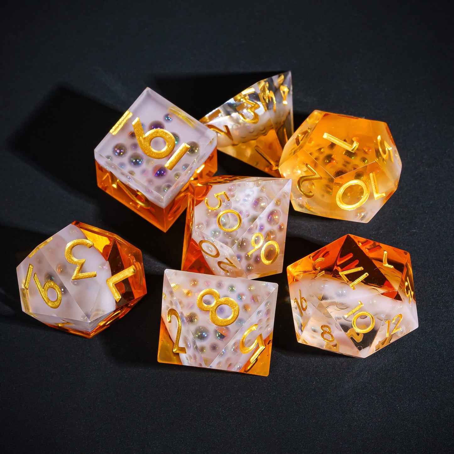 Crisp Brew Sharp Edge Dice Set grouped on black surface showing frosted resin and amber tones