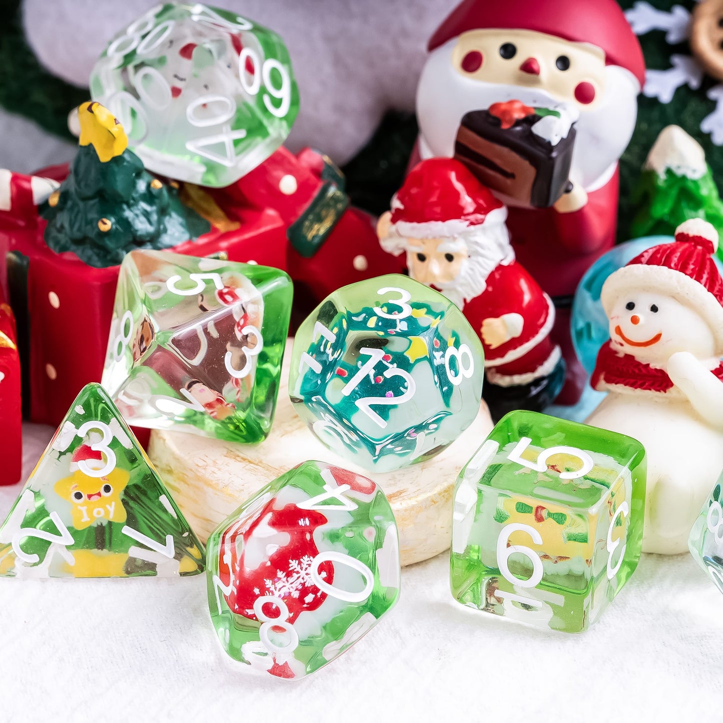 Critmas Crew resin Dice Set displayed with Santa and snowman decorations for DnD and tabletop RPGs