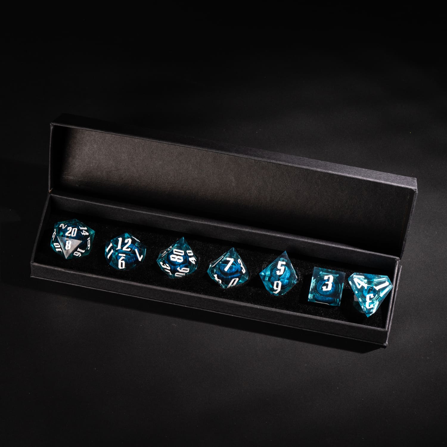 Dragon Eye Blue sharp edge DnD dice set displayed inside premium black Only Crits box