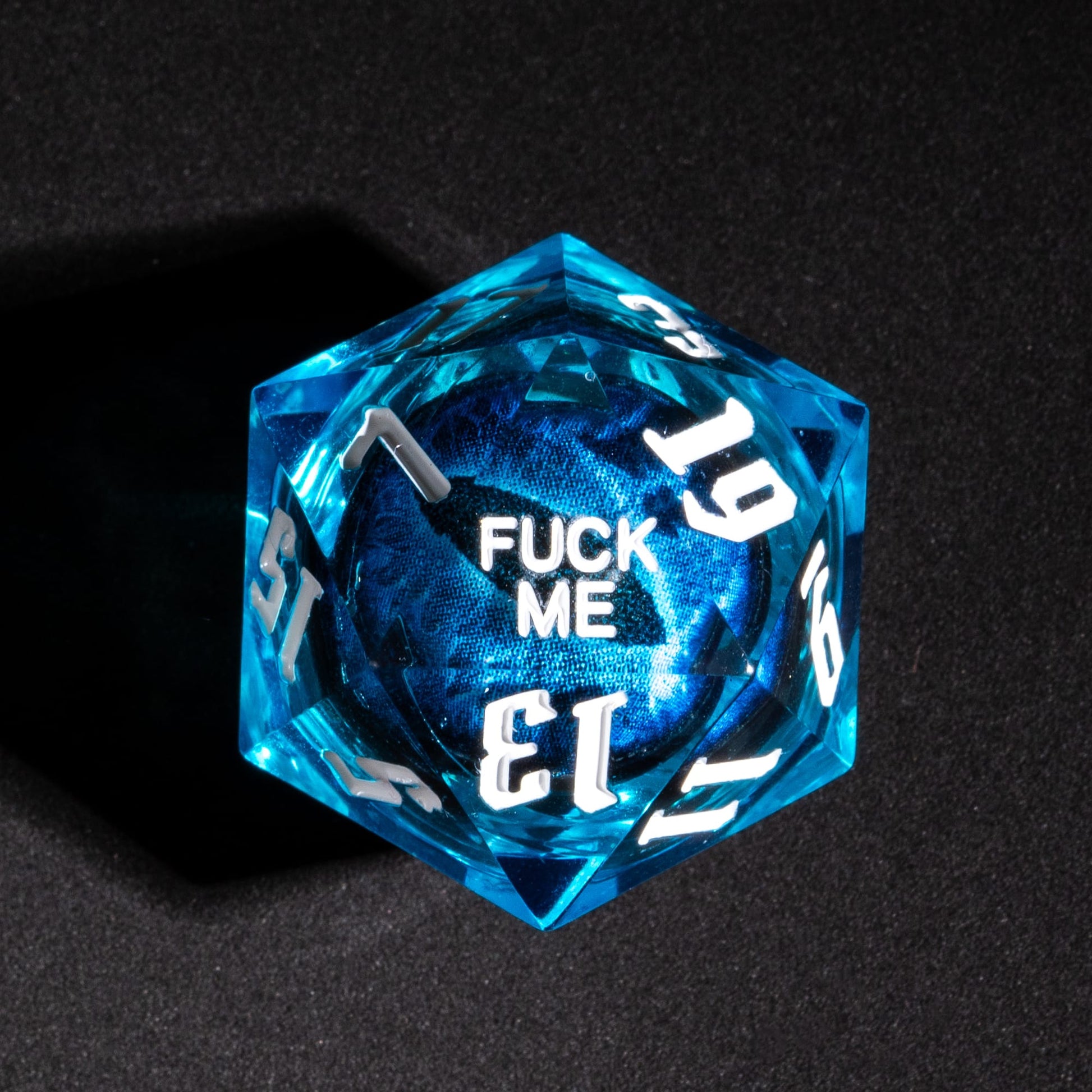 Closeup of D20 showing Fuck Me face from Dragon Eye Blue Fuck Me Sharp Edge Dice Set