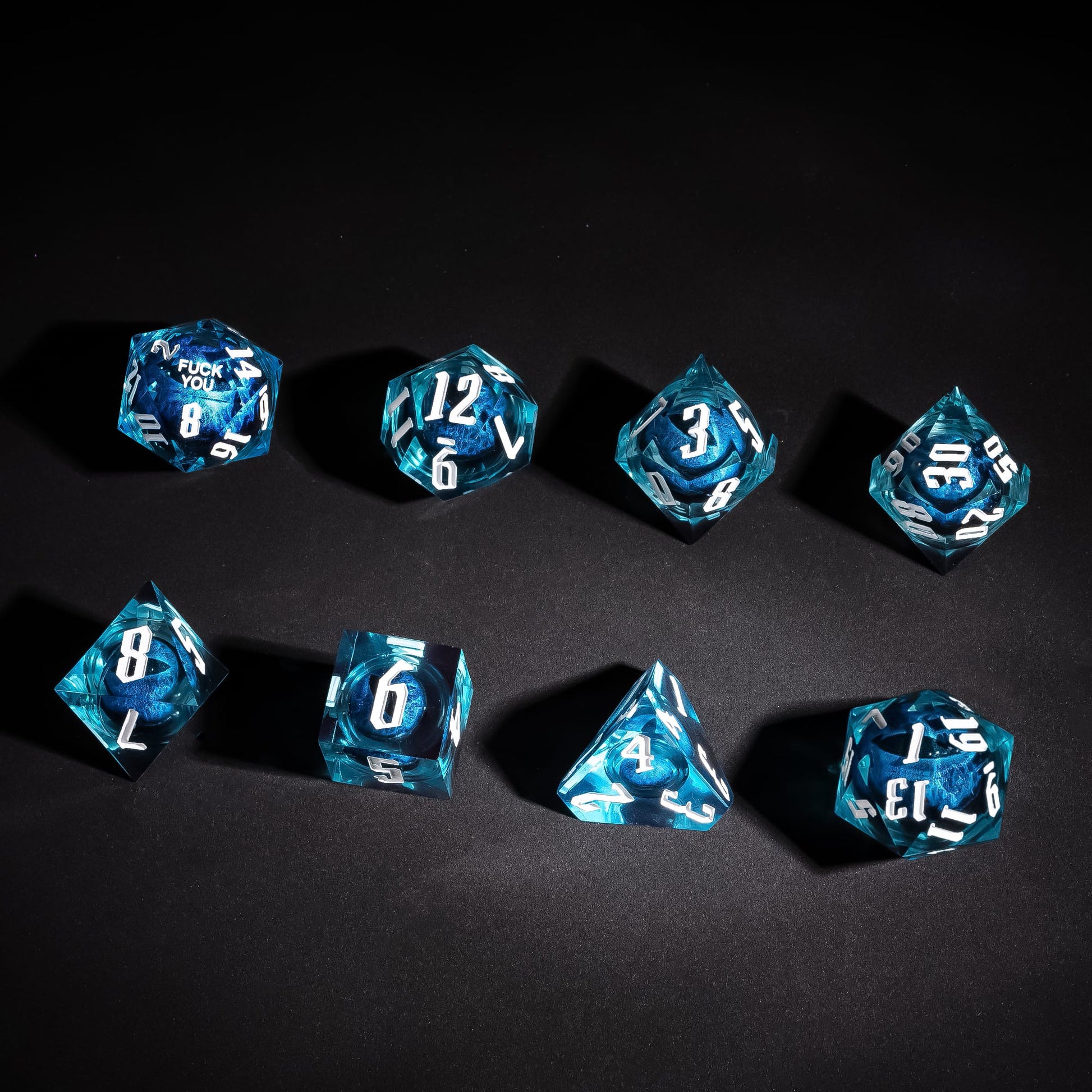 Overhead display of Dragon Eye Blue F Me Sharp Edge Dice Set with white numbering for DnD
