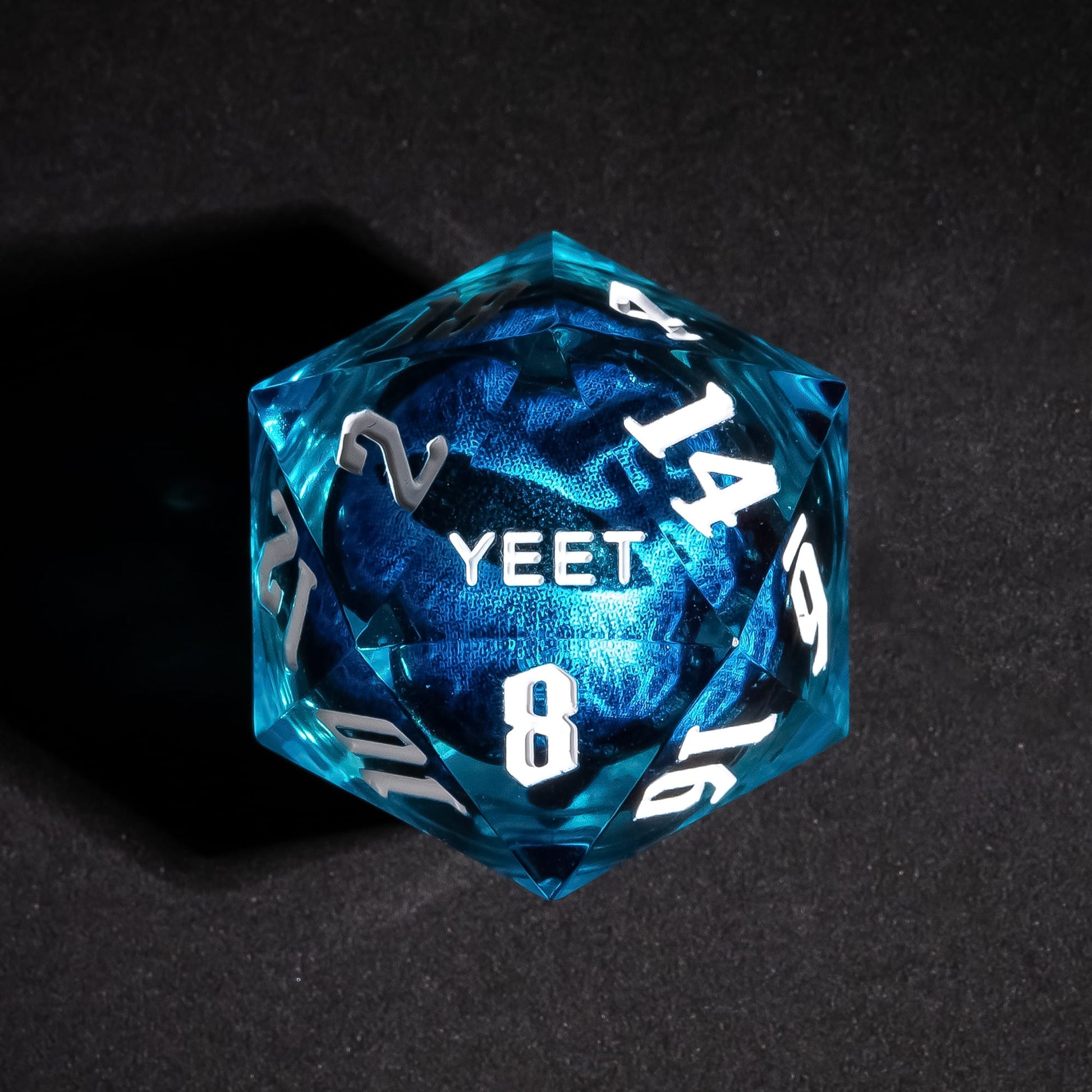 Close up of Dragon Eye Blue Sharp Edge D20 with YEET face for DnD dice
