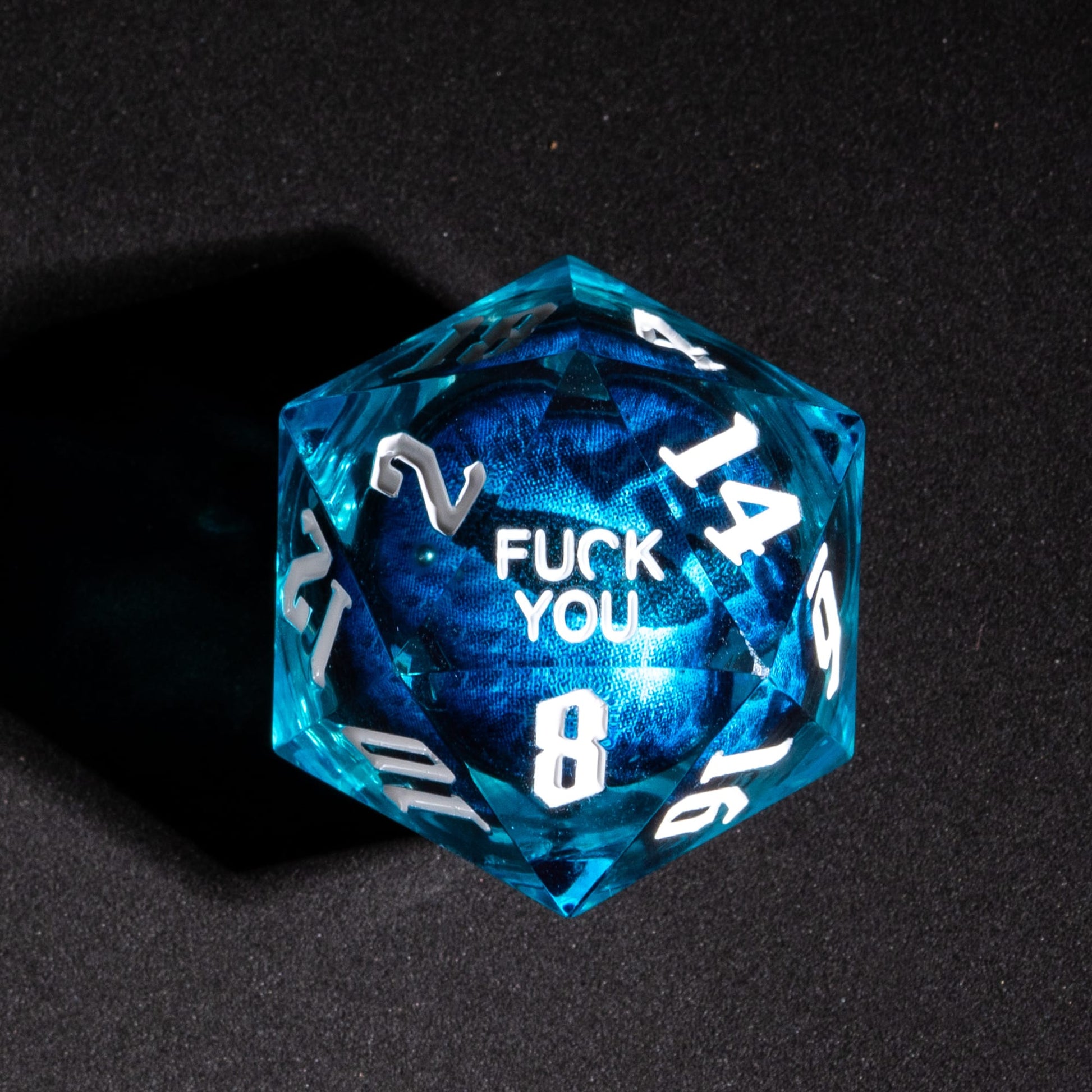 Closeup of D20 showing Fuck You face from Dragon Eye Blue Fuck Me Sharp Edge Dice Set