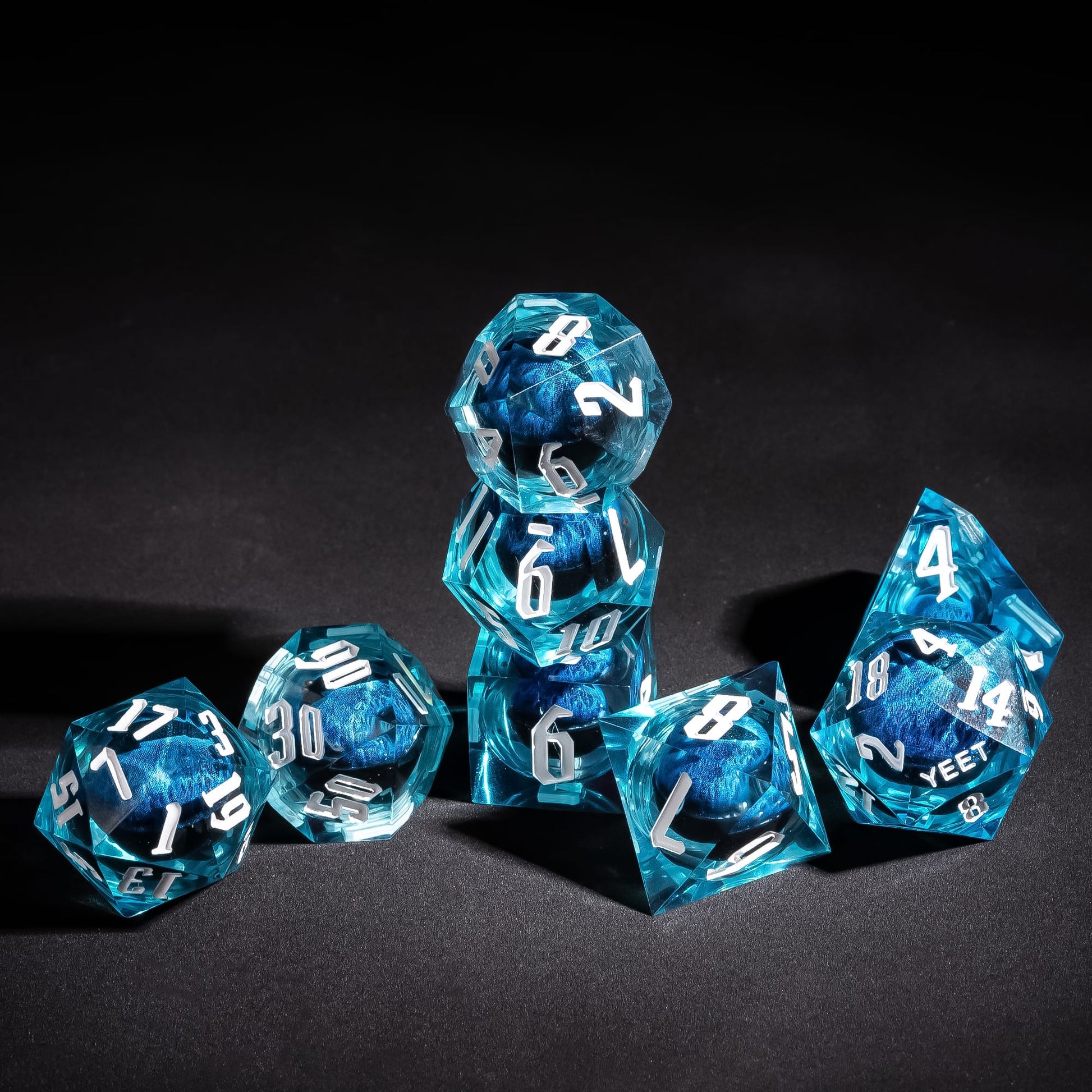 Stacked display of Dragon Eye Blue Yeet Sharp Edge Dice Set for DnD dice collectors