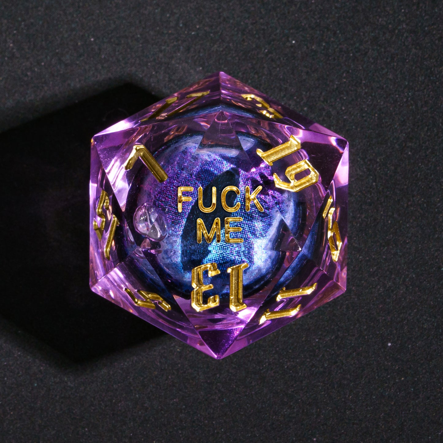 Closeup of D20 showing Fuck Me face from Dragon Eye Purple Sharp Edge Dice Set