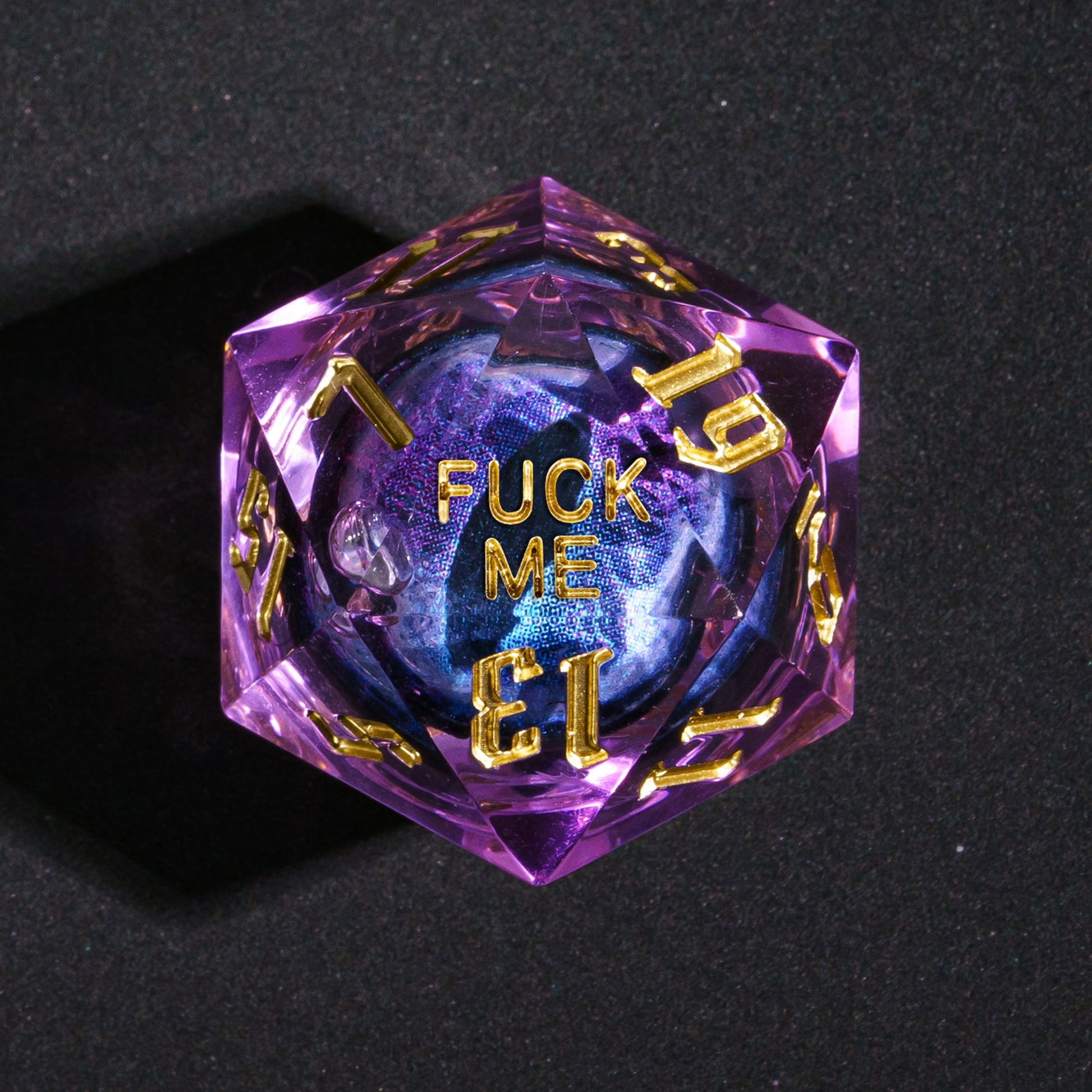 Closeup of D20 showing Fuck Me face from Dragon Eye Purple Sharp Edge Dice Set