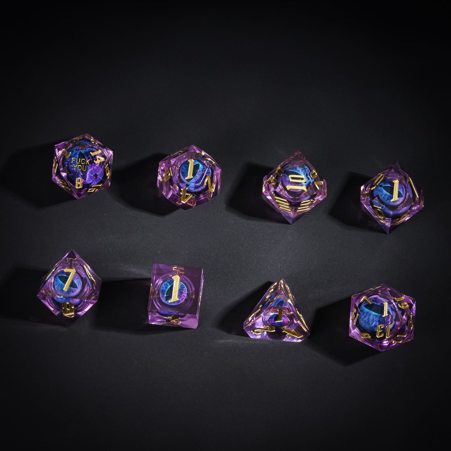 Overhead display of Dragon Eye Purple Fuck Me Sharp Edge Dice Set with gold numbering for DnD