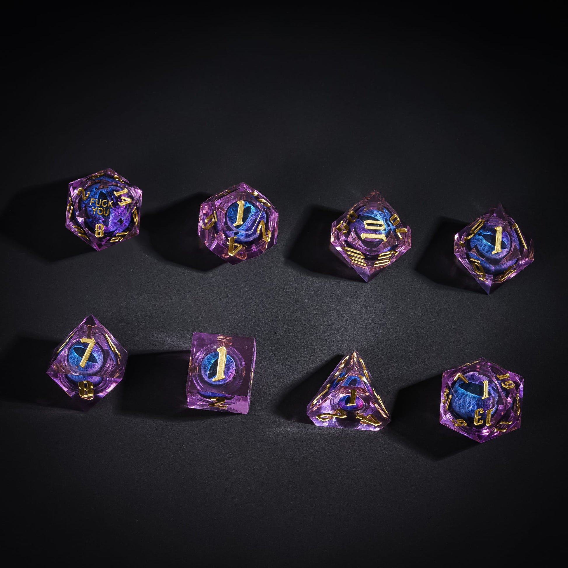 Overhead display of Dragon Eye Purple Fuck Me Sharp Edge Dice Set with gold numbering for DnD