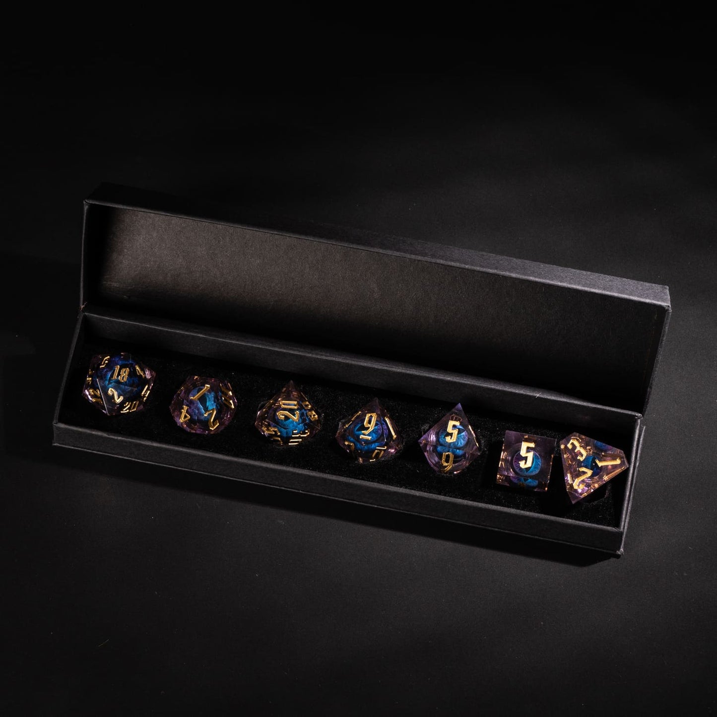 Dragon Eye Purple sharp edge resin dice set with gold numbering displayed in black presentation box