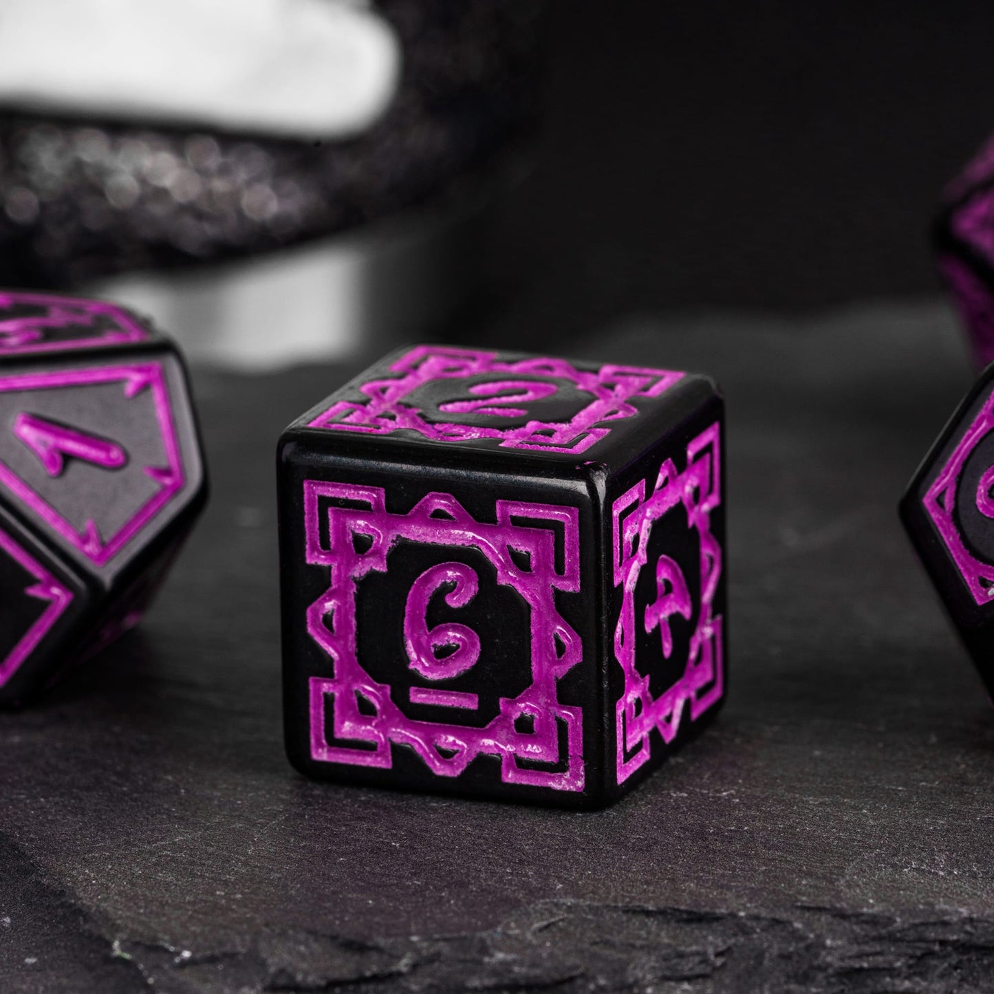 Close-up of black & purple Druidic Life D6 die showing ornate details