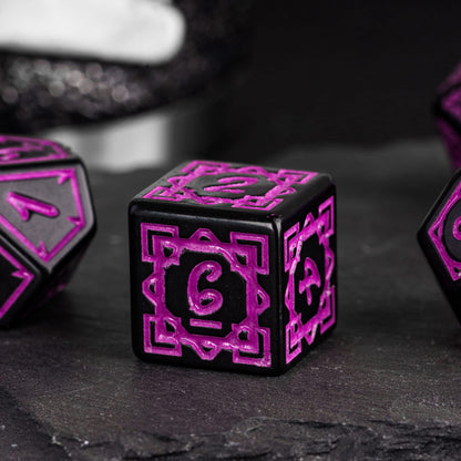 Close-up of black & purple Druidic Life D6 die showing ornate details