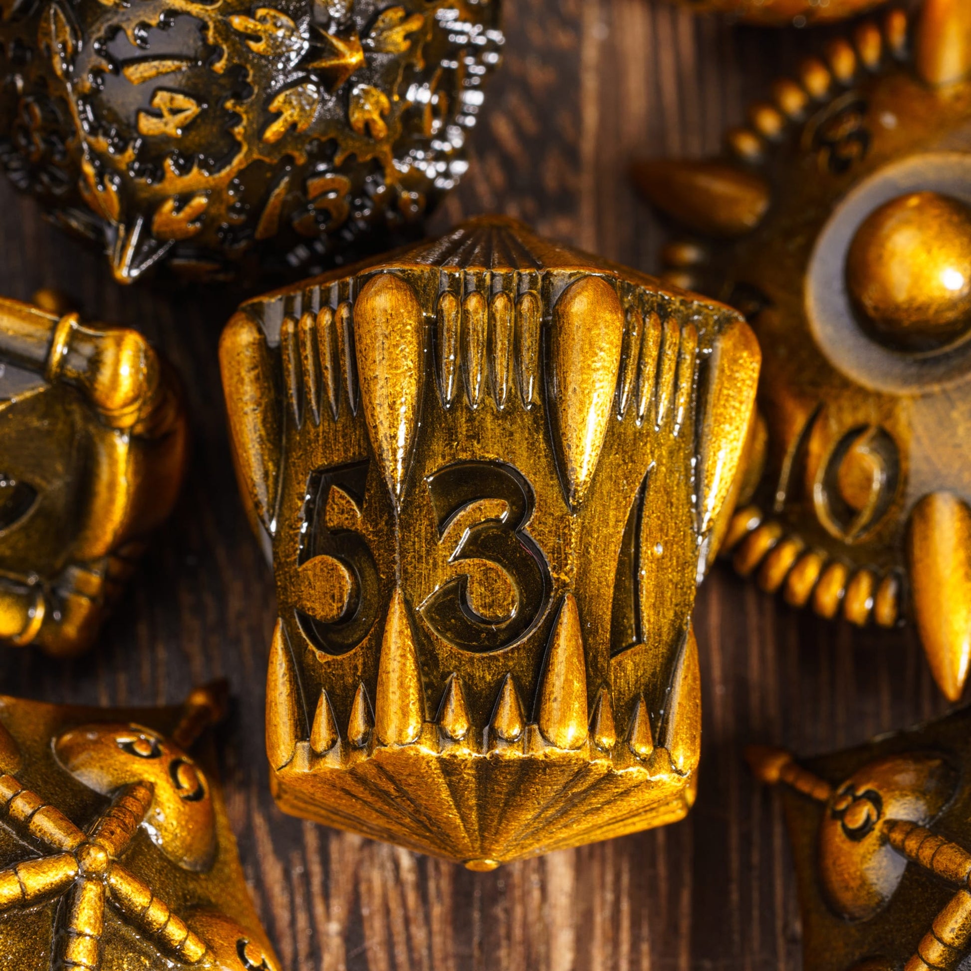 Close-up of Eldritch Edge Ancient Gold Metal Dice Collection showing intricate spiked d100 design for DnD & tabletop RPGs