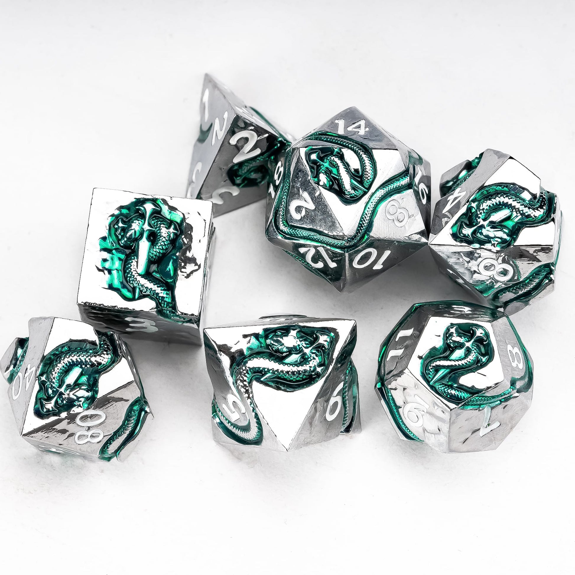 Emerald Serpent metal dice set arranged in circle flat lay showing engraved serpent details