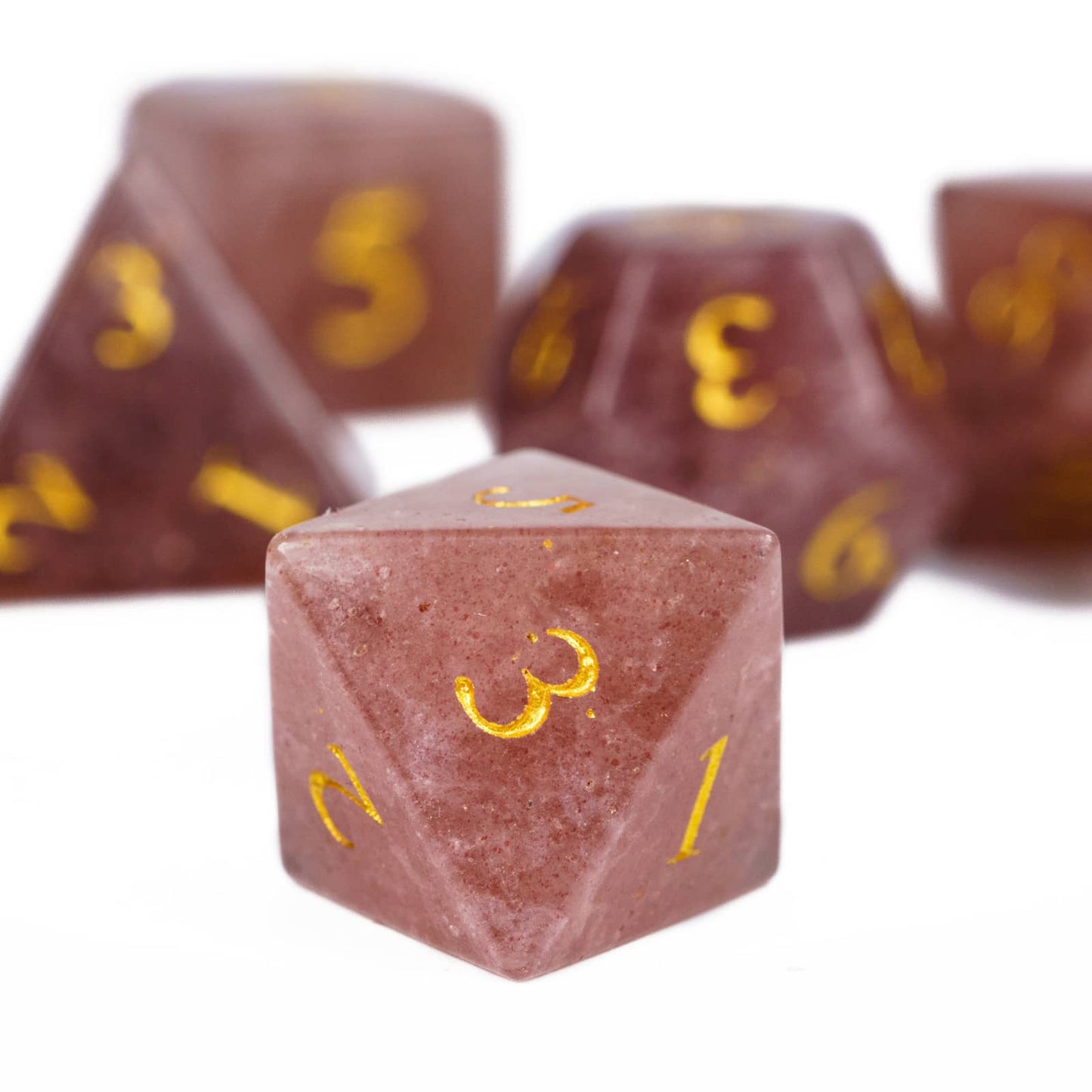 Closeup of Ember Rose stone D20 dice from Fabled Crystals Stone Dice Series for DnD and tabletop roleplaying games