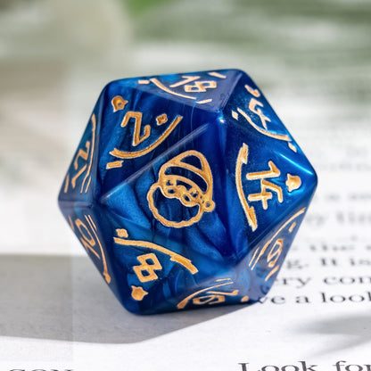 Macro shot of blue Festive Fate D20 dice featuring Santa engraving and gold ink for DnD Christmas campaigns