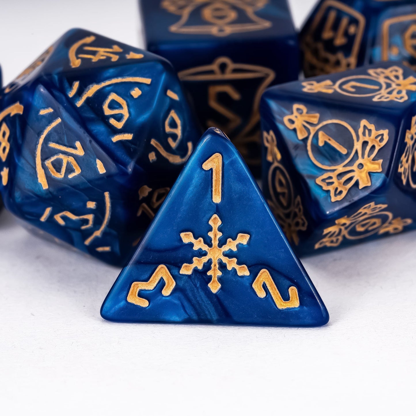 Close up of blue Festive Fate D4 with snowflake icon and gold numbering for holiday DND