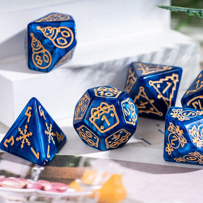 Blue Festive Fate Christmas dice set with gold icons displayed on holiday themed tabletop scene
