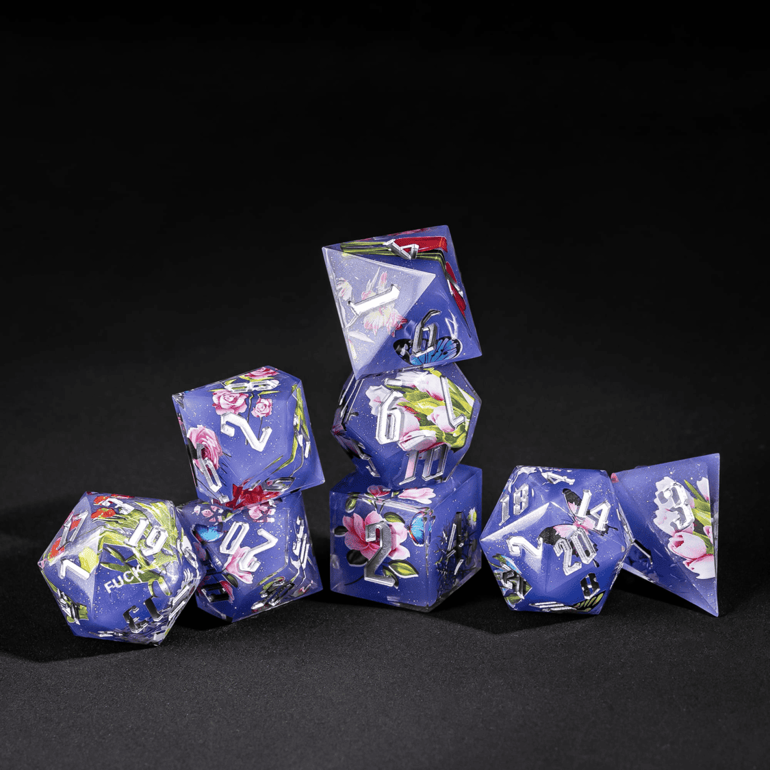 Stacked Floral Eclipse Sharp Edge Dice Set with purple floral designs for DnD gameplay