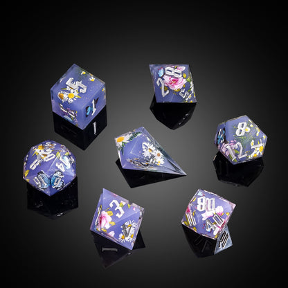 Flat lay of Floral Eclipse Sharp Edge Dice Set 7 piece botanical resin dice collection for DnD and DnD 5e