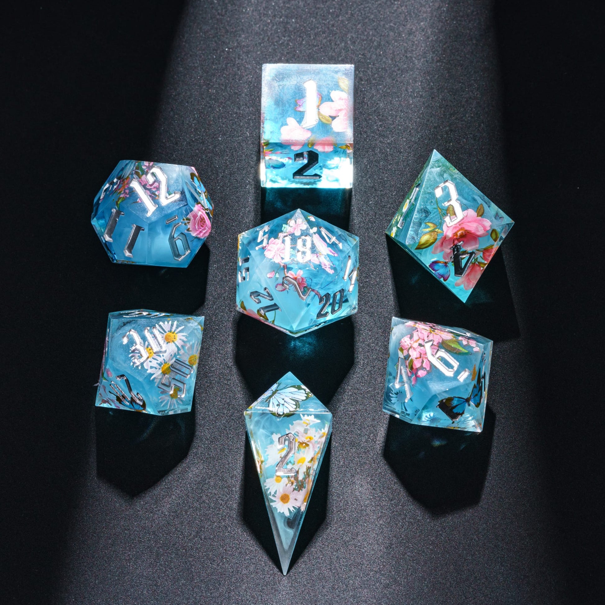 Floral Mist Sharp Edge Dice Set flat lay on black background, 7 piece RPG dice set for DnD campaigns