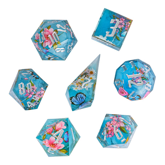 Flat lay of Floral Mist Sharp Edge Dice Set, 7 piece resin dice collection for Dungeons & Dragons 5e