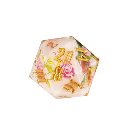 Close up of Floral Radiance Sharp Edge D20 with pink roses inside ivory resin and engraved metallic gold numbering