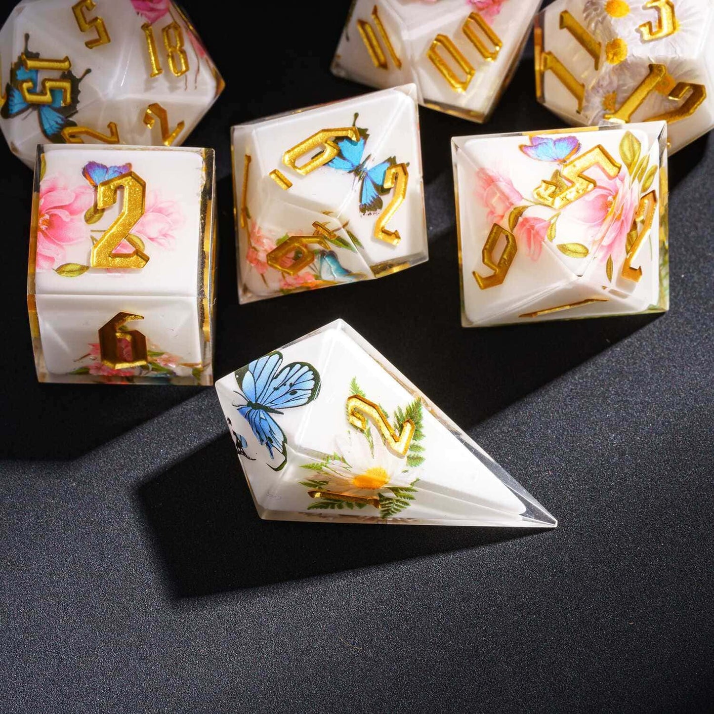 Floral Radiance Sharp Edge Dice Set flat lay showing botanical artwork and gold engraved numbers for DnD