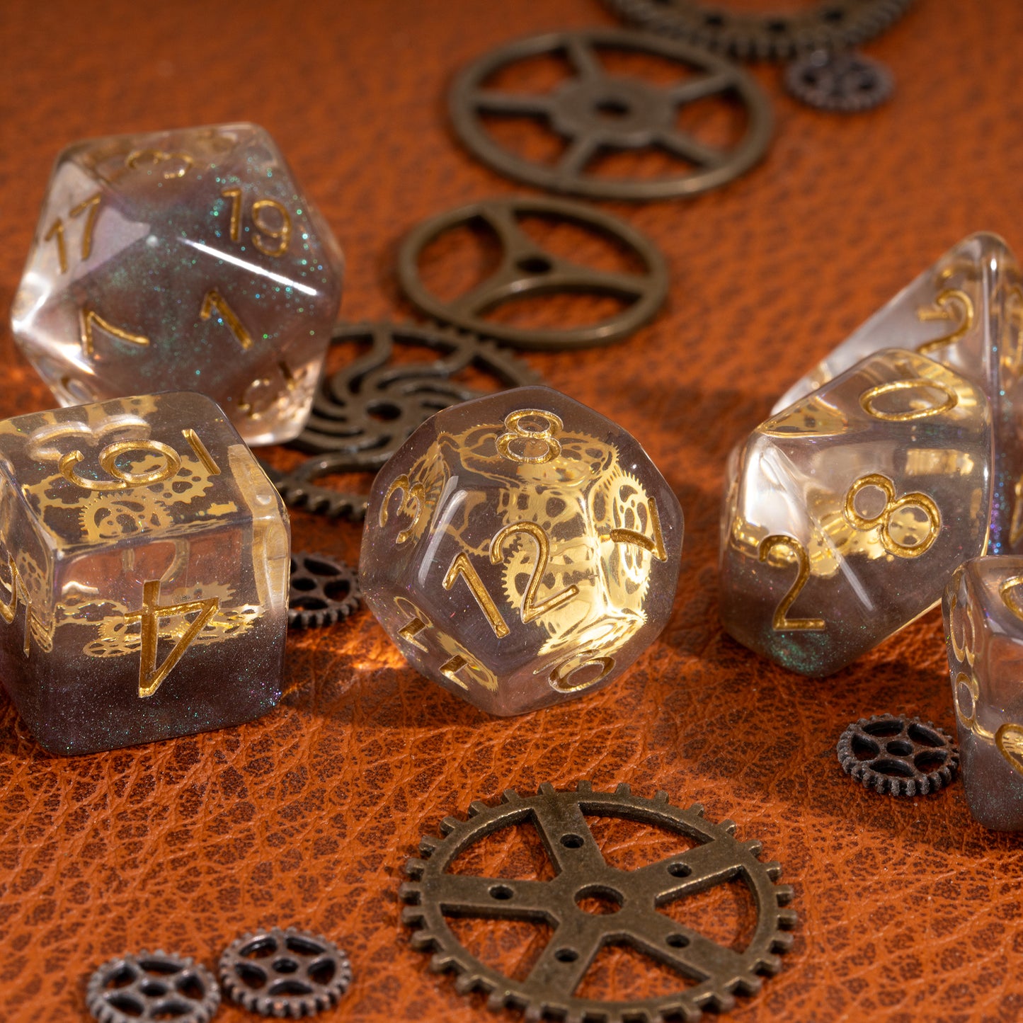Flux Gearshift Dice Set lifestyle close-up featuring translucent resin dice with embedded golden gears on a leather background