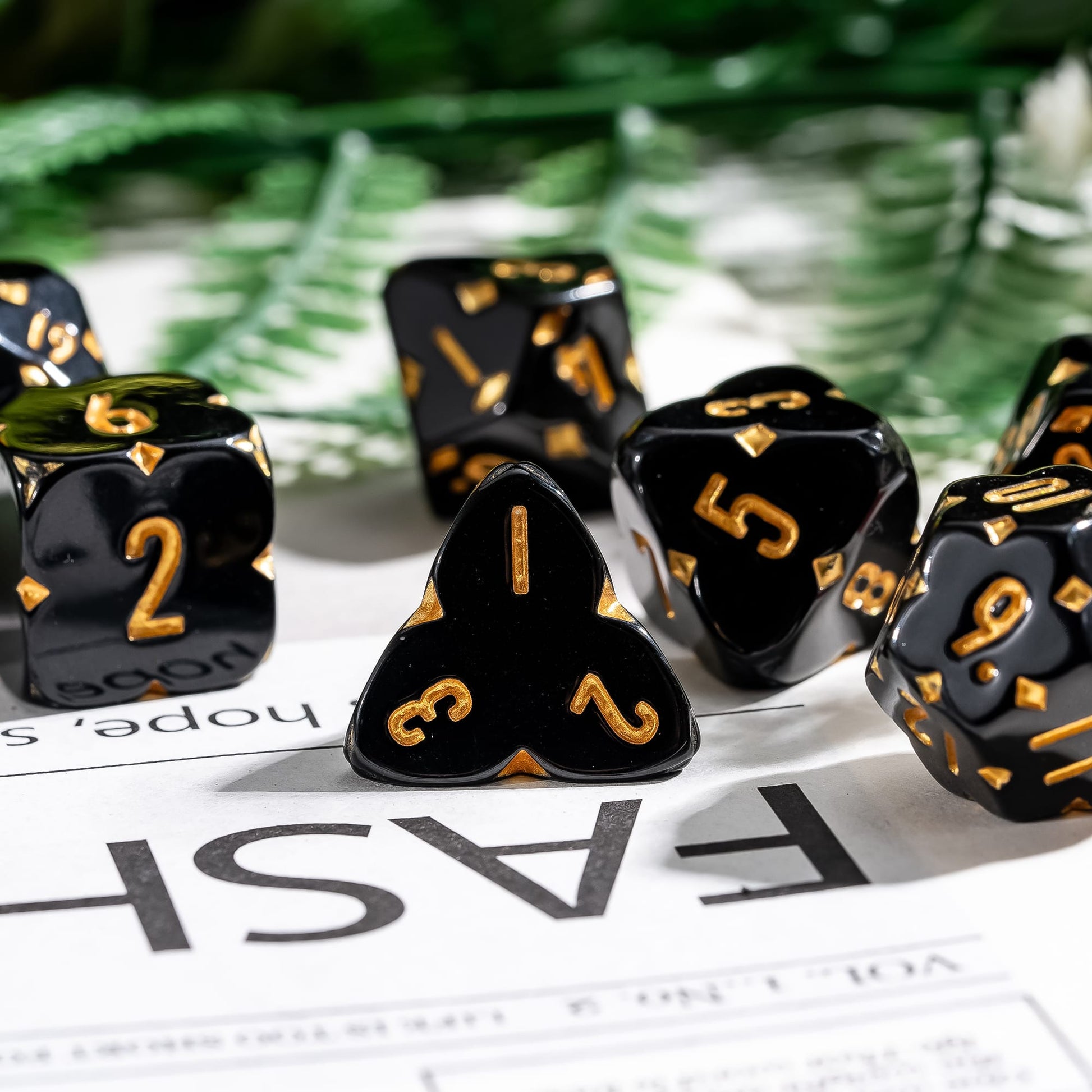 Close-up of Black Fourfold Clover Dice Set, gold numbers with clover symbols for DnD & DnD 5e