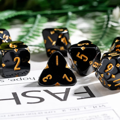 Close-up of Black Fourfold Clover Dice Set, gold numbers with clover symbols for DnD & DnD 5e