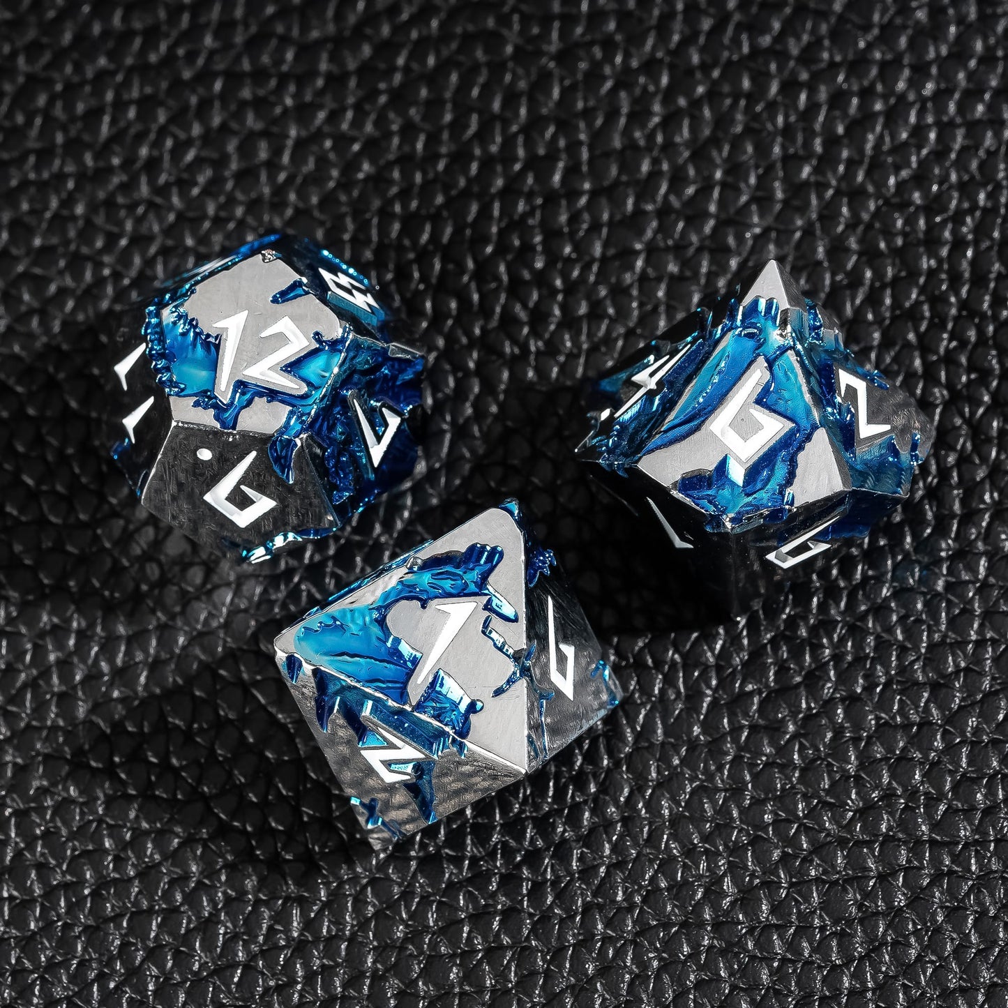 Close-up of Frost Tide Dragon metal dice showing blue tide texture on silver metal