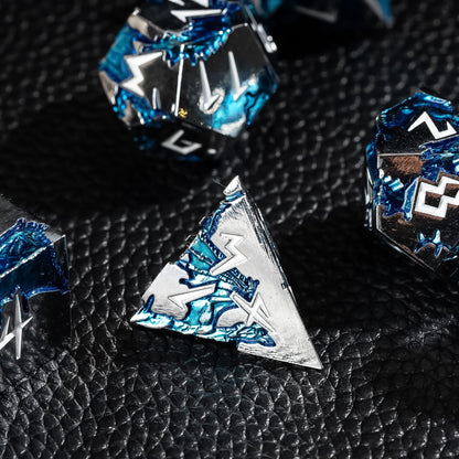 Close-up of Frost Tide Dragon D4 metal dice with silver finish and blue wave detailing