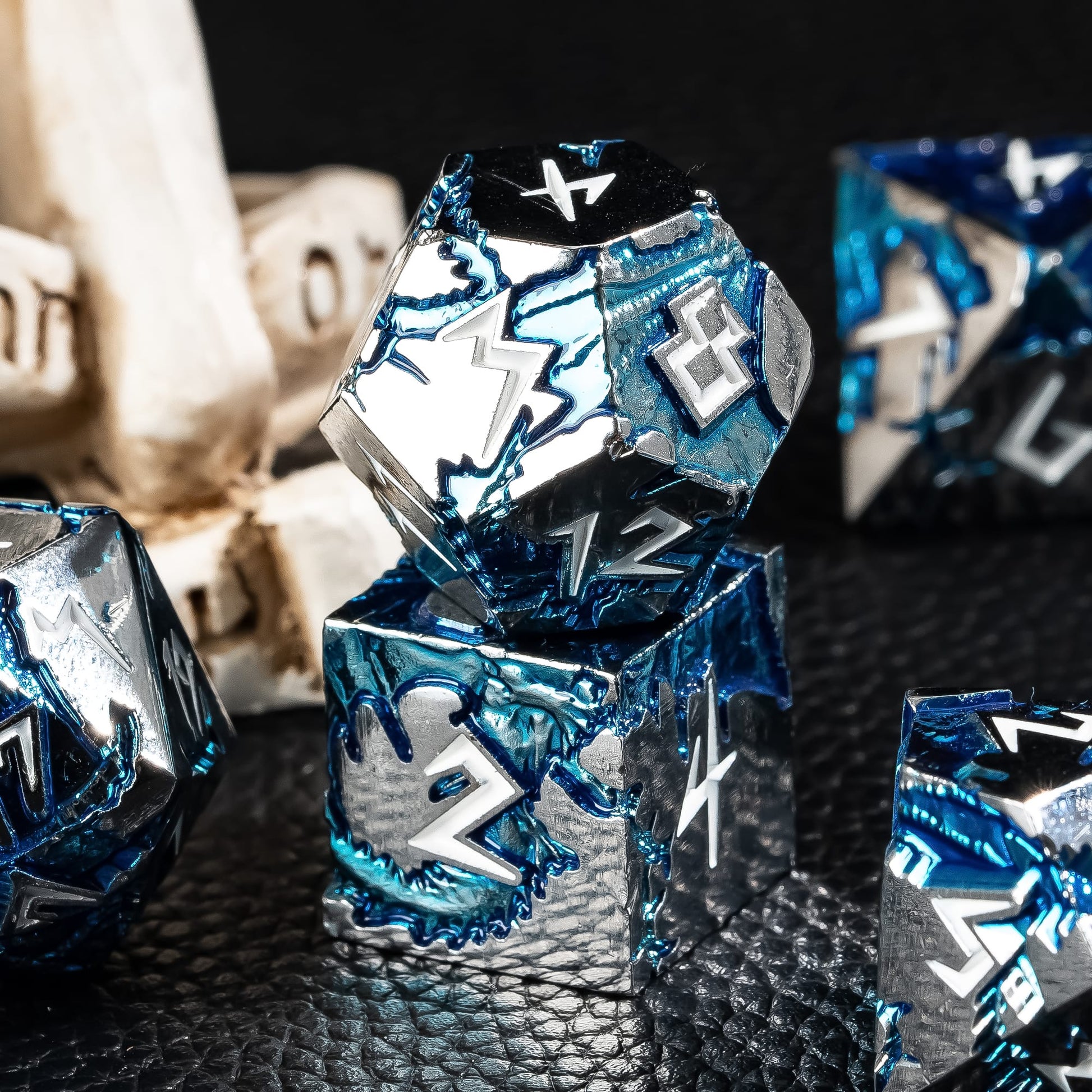 Detailed view of Frost Tide Dragon metal dice with engraved numbers and blue tide fill