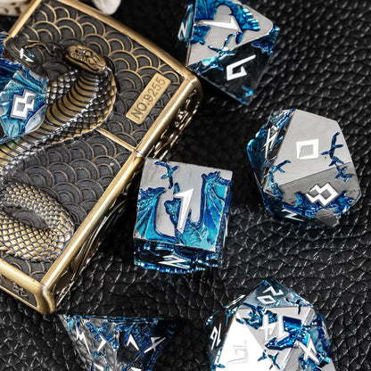Frost Tide Dragon metal dice beside engraved serpent dice box on textured surface