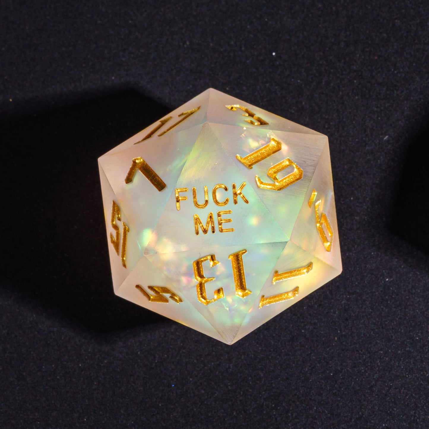 Close up of Frosted Beam Fuck Me D20 with glowing resin and gold numbers