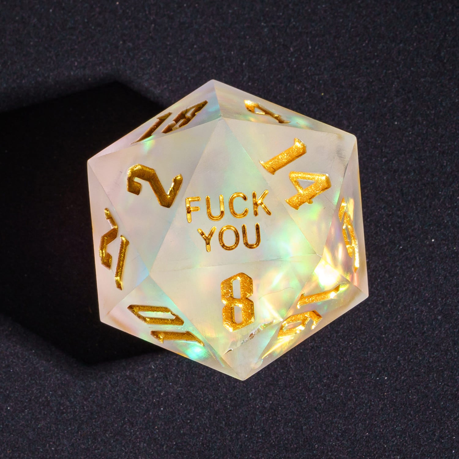 Close up of Frosted Beam Fuck You D20 with pearlescent glow and gold numbers