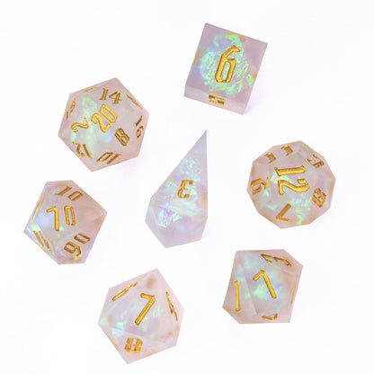 Flat lay of Frosted Beam sharp edge dice set with gold numbering on white background