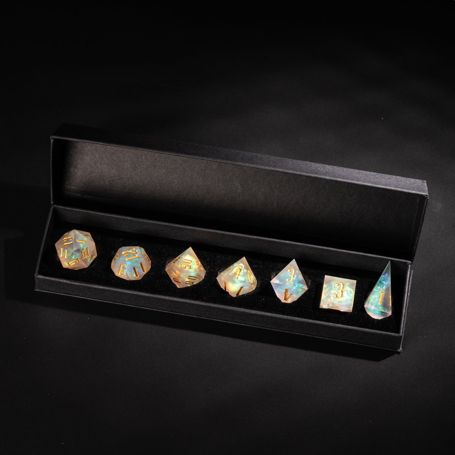 Frosted Beam resin dice set displayed in black box with gold numbers and opalescent finish