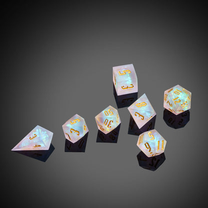 Frosted Beam sharp edge dice set arranged on dark surface with reflective lighting