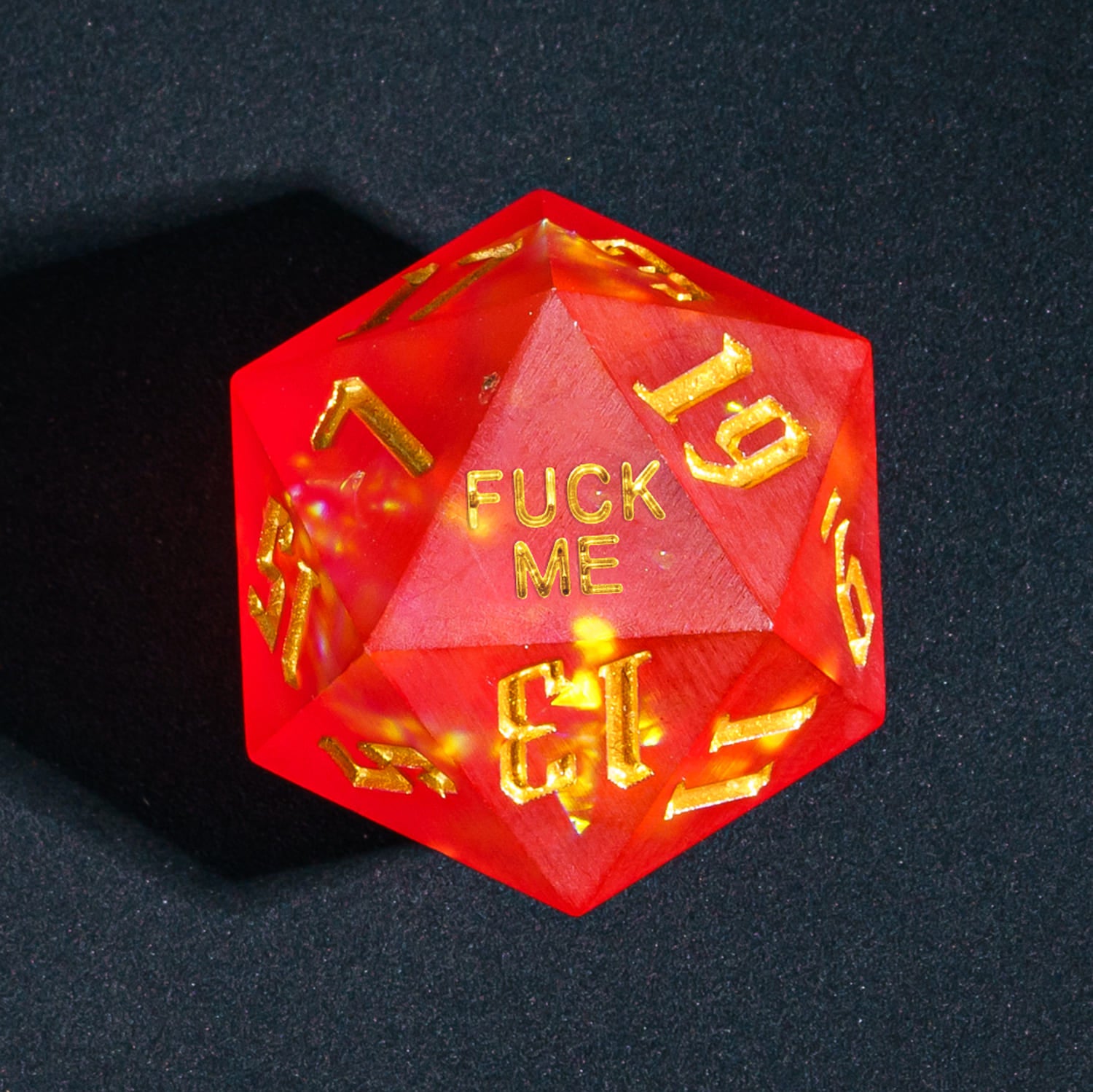 Close up of Frosted Ember Sharp Edge D20 with Fuck Me face for DnD dice